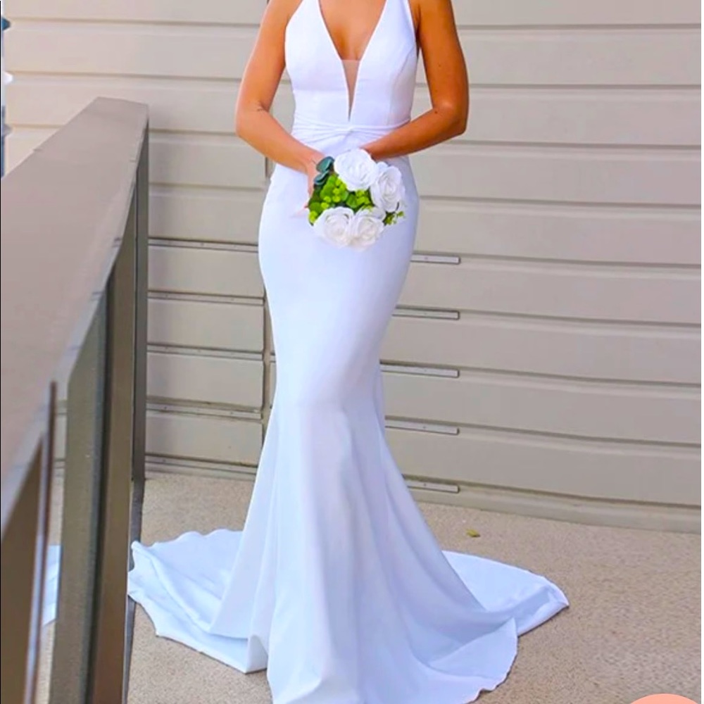 Never worn, white wedding dress.